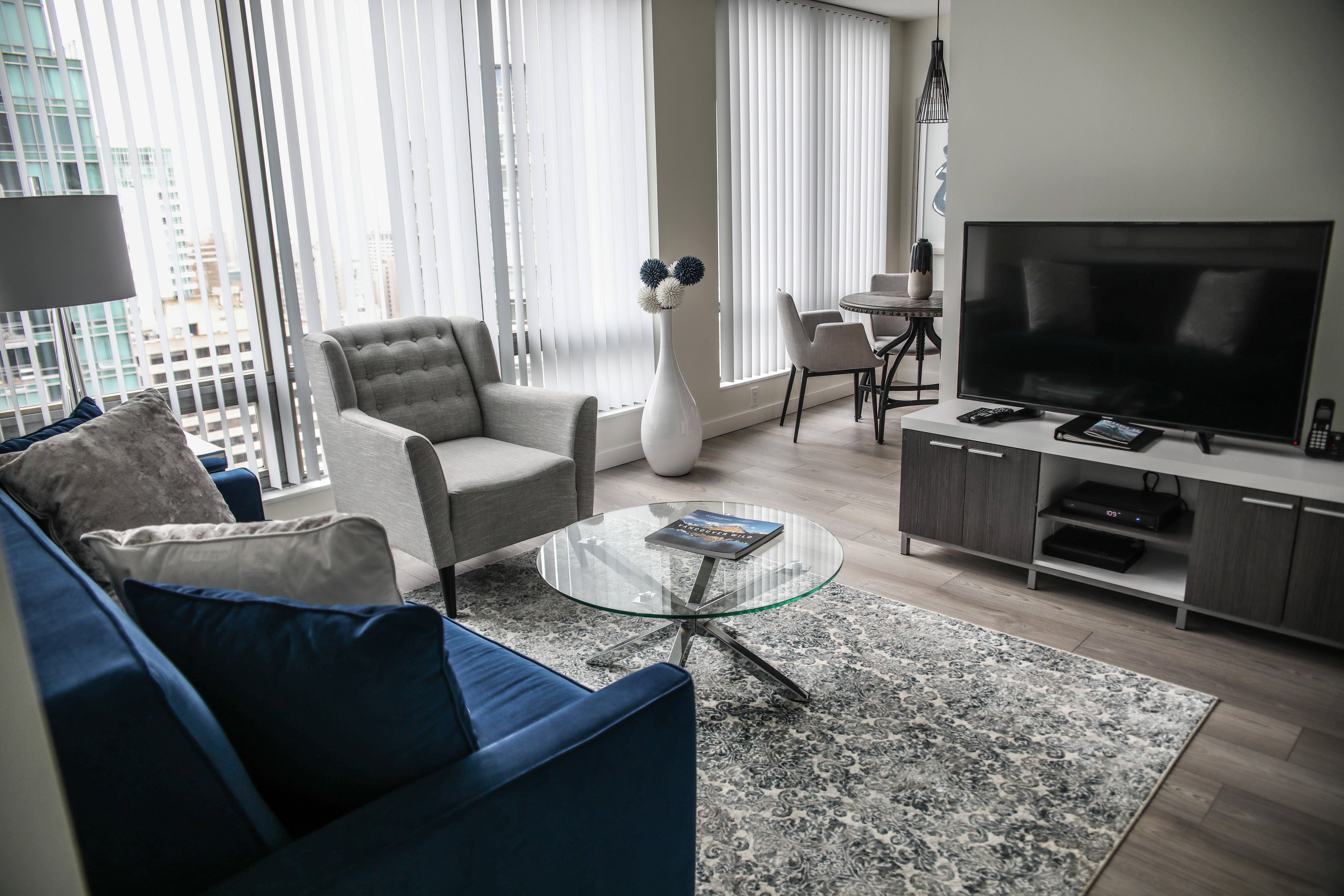 furnished living room with blue sofa at Vancouver Extended Stay